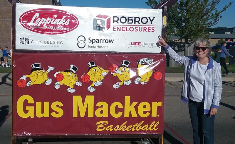 Robroy employee with Gus Macker Basketball Tournament sign